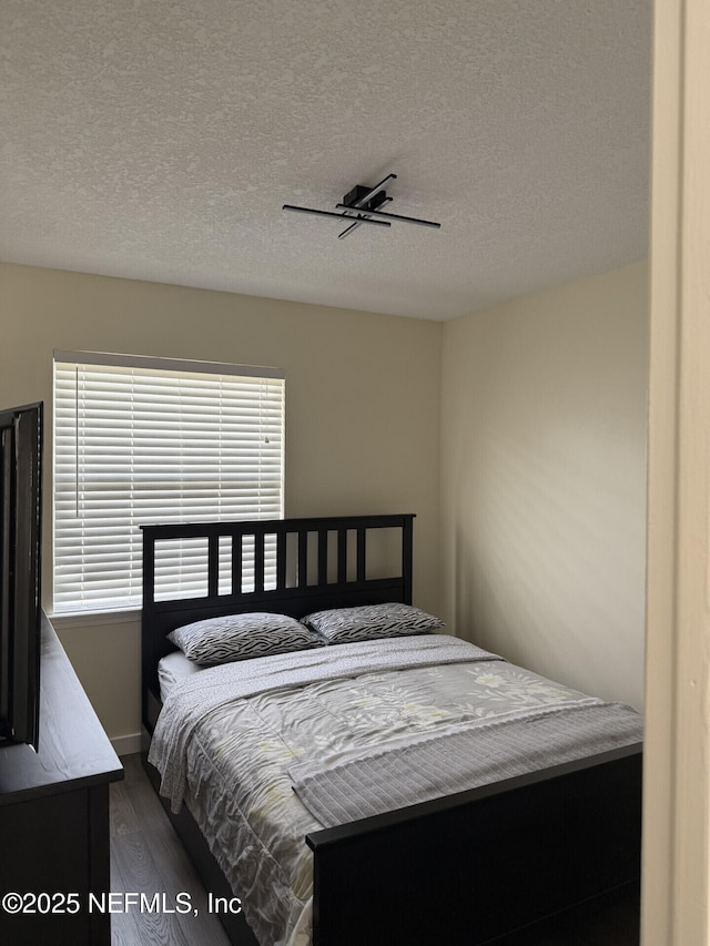 13248 Grant Logan Ln, Jacksonville, FL 32225 - bedroom with a textured ceiling, ceiling fan, and wood finished floors