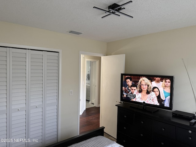 13248 Grant Logan Ln, Jacksonville, FL 32225 - bedroom with visible vents, a closet, wood finished floors, and a textured ceiling