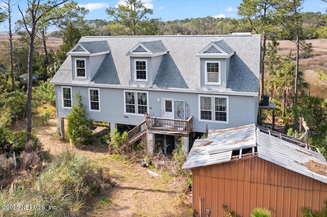 94245 Palm Cir W, Fernandina Beach, FL 32034 - view of front facade with a shingled roof, a wooden deck, and stairway