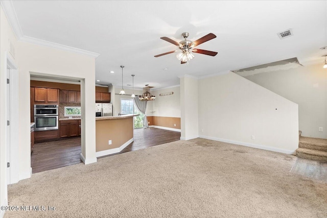 94245 Palm Cir W, Fernandina Beach, FL 32034 - unfurnished living room featuring crown molding, carpet floors, visible vents, and a ceiling fan