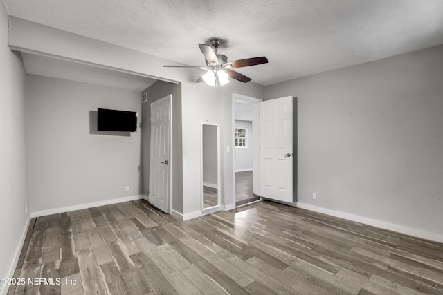 6013 Edgefield Dr, Jacksonville, FL 32205 - unfurnished bedroom featuring baseboards, wood finished floors, ceiling fan, and a textured ceiling