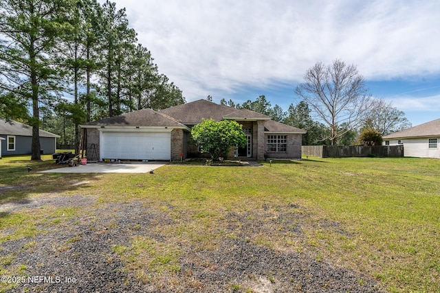9587 Ford Rd, Bryceville, FL 32009 - view of front of home featuring fence, an attached garage, driveway, a front lawn, and brick siding
