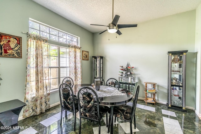 9587 Ford Rd, Bryceville, FL 32009 - dining room featuring baseboards, a textured ceiling, and a ceiling fan