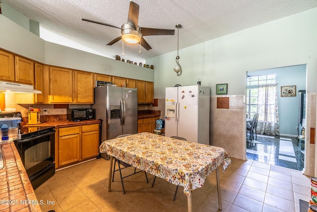 9587 Ford Rd, Bryceville, FL 32009 - kitchen featuring light tile patterned floors, under cabinet range hood, black appliances, and a ceiling fan