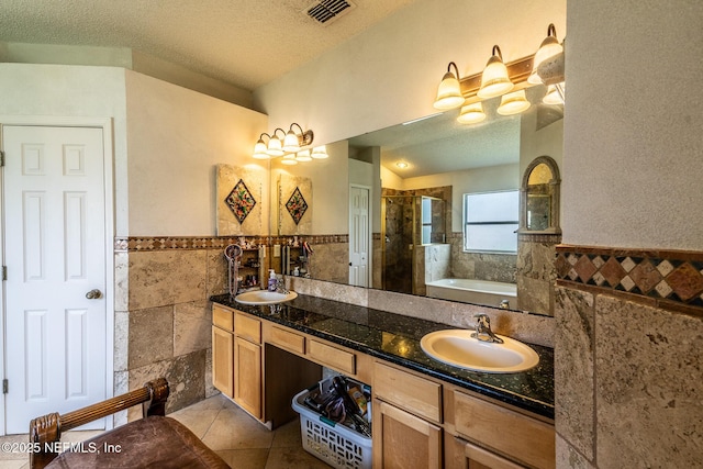 9587 Ford Rd, Bryceville, FL 32009 - bathroom featuring tile walls, visible vents, a textured ceiling, and a sink