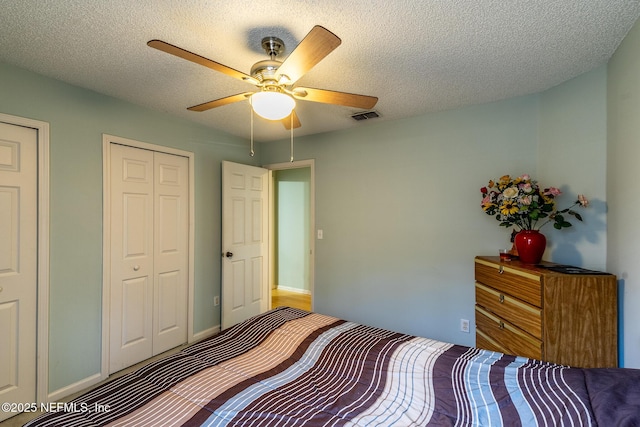 9587 Ford Rd, Bryceville, FL 32009 - bedroom with a textured ceiling, baseboards, ceiling fan, and visible vents
