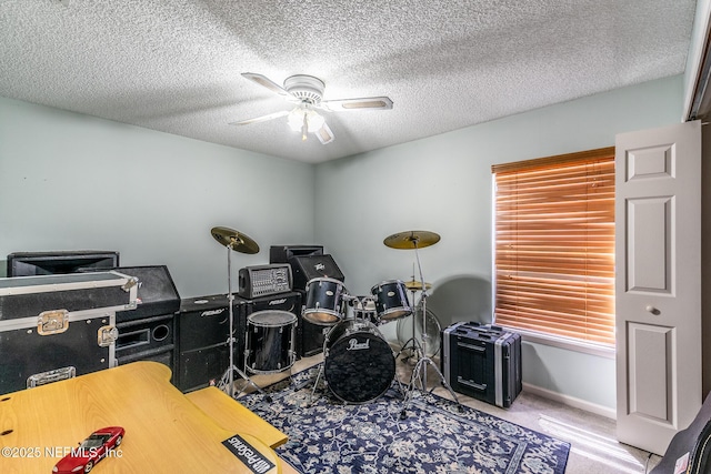 9587 Ford Rd, Bryceville, FL 32009 - rec room with a textured ceiling, carpet flooring, ceiling fan, and baseboards