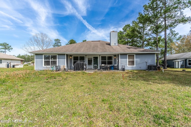 9587 Ford Rd, Bryceville, FL 32009 - back of property featuring a chimney, central air condition unit, and a yard