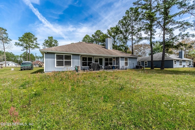 9587 Ford Rd, Bryceville, FL 32009 - rear view of house with a lawn and a chimney