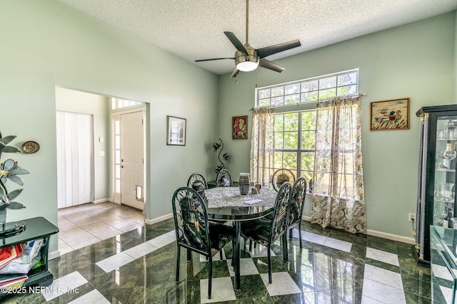 9587 Ford Rd, Bryceville, FL 32009 - dining area with a textured ceiling, a high ceiling, baseboards, and a ceiling fan