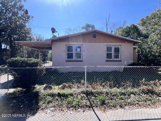 2318 W 45th St, Jacksonville, FL 32209 - view of side of property featuring a carport and fence