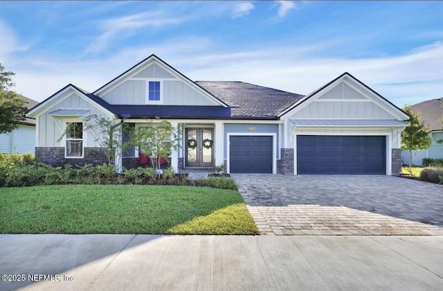 1021 Oakland Hills Ave, Middleburg, FL 32068 - craftsman-style home featuring an attached garage, stone siding, board and batten siding, decorative driveway, and a front lawn