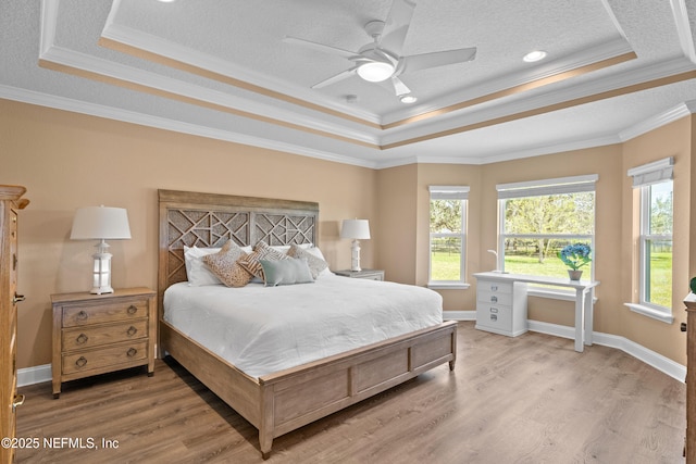 116 Providence Dr, Saint Augustine, FL 32092 - bedroom featuring a textured ceiling, crown molding, baseboards, wood finished floors, and a tray ceiling