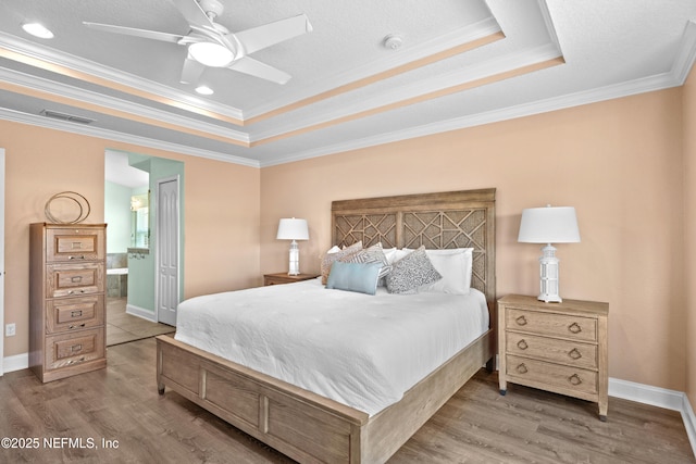 116 Providence Dr, Saint Augustine, FL 32092 - bedroom featuring ensuite bathroom, visible vents, ornamental molding, wood finished floors, and a tray ceiling