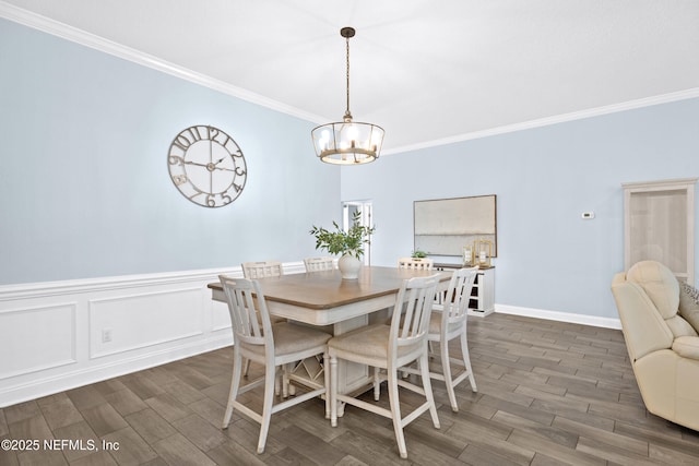 116 Providence Dr, Saint Augustine, FL 32092 - dining space featuring wood tiled floor, ornamental molding, and an inviting chandelier