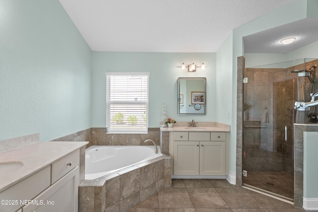 116 Providence Dr, Saint Augustine, FL 32092 - full bath with a stall shower, a sink, two vanities, a textured ceiling, and a bath