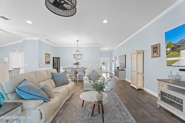 116 Providence Dr, Saint Augustine, FL 32092 - living room featuring a textured ceiling, visible vents, dark wood-style flooring, and an inviting chandelier