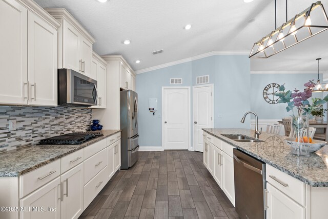116 Providence Dr, Saint Augustine, FL 32092 - kitchen with decorative backsplash, a sink, visible vents, a kitchen island with sink, and appliances with stainless steel finishes