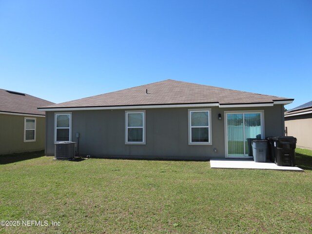3282 Little Fawn Ln, Green Cove Springs, FL 32043 - back of property featuring central air condition unit, a shingled roof, and a yard