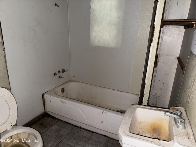 bathroom with a sink, toilet, and a bath