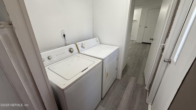123 Kolski Dr, Crescent City, FL 32112 - washroom featuring laundry area, separate washer and dryer, and light wood-type flooring