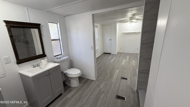 123 Kolski Dr, Crescent City, FL 32112 - bathroom featuring vanity, toilet, ceiling fan, visible vents, and wood finished floors
