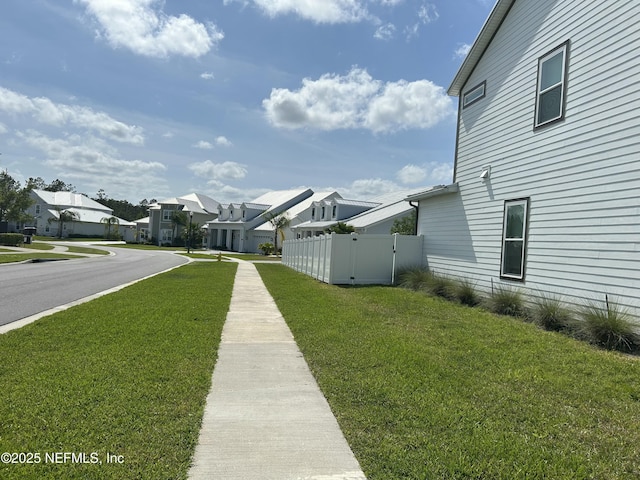 exterior space with a residential view, a gate, and fence