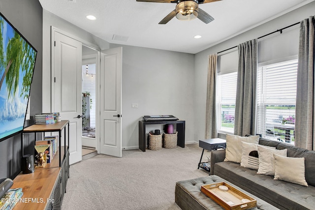 carpeted living area with baseboards, visible vents, recessed lighting, and a ceiling fan