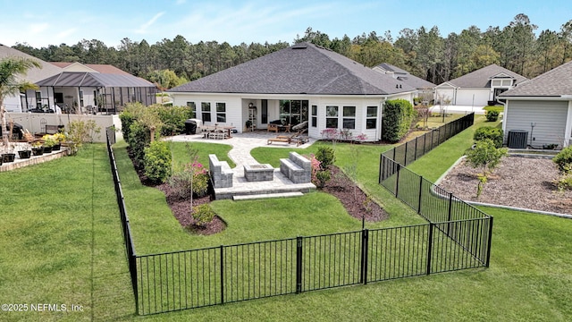 rear view of house featuring a patio area, roof with shingles, cooling unit, a fenced backyard, and a lawn
