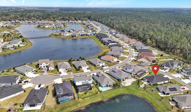 birds eye view of property featuring a residential view, a water view, and a view of trees