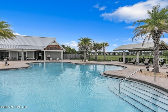 pool with fence and a patio area