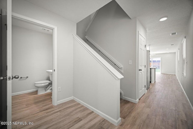 8910 Free Ave, Jacksonville, FL 32211 - hallway with wood finished floors, baseboards, visible vents, and stairs