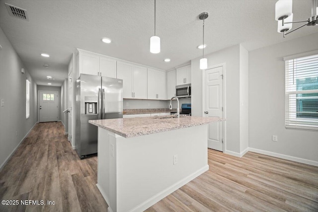 8910 Free Ave, Jacksonville, FL 32211 - kitchen with stainless steel appliances, a wealth of natural light, white cabinets, and a sink