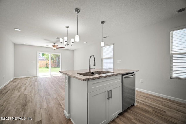 8910 Free Ave, Jacksonville, FL 32211 - kitchen featuring wood finished floors, dishwasher, a sink, open floor plan, and decorative light fixtures