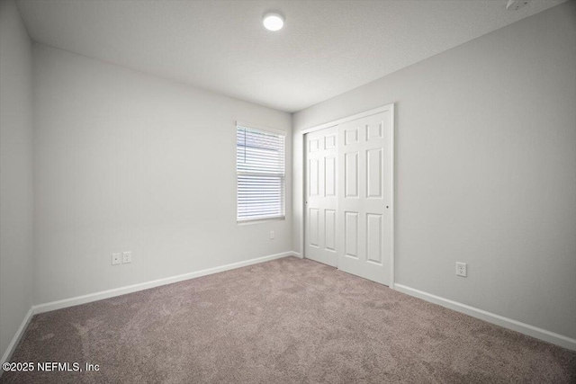 8910 Free Ave, Jacksonville, FL 32211 - unfurnished bedroom with a closet, baseboards, and carpet floors