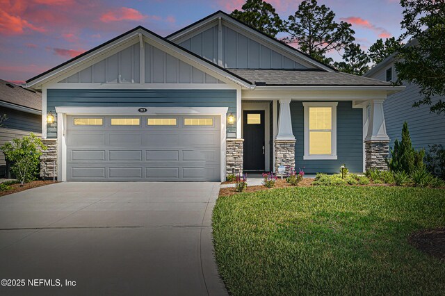 212 Fawnwood St, Saint Johns, FL 32259 - craftsman-style house with stone siding, an attached garage, board and batten siding, driveway, and a yard