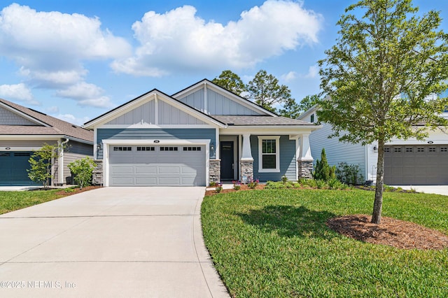 212 Fawnwood St, Saint Johns, FL 32259 - craftsman-style house with stone siding, an attached garage, a front lawn, board and batten siding, and driveway