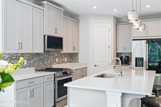 212 Fawnwood St, Saint Johns, FL 32259 - kitchen featuring light countertops, a kitchen bar, stainless steel appliances, gray cabinetry, and a sink