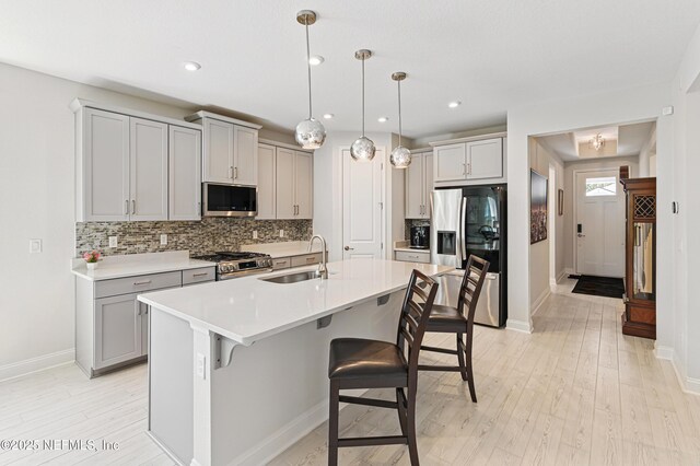 212 Fawnwood St, Saint Johns, FL 32259 - kitchen with gray cabinets, a sink, tasteful backsplash, and appliances with stainless steel finishes