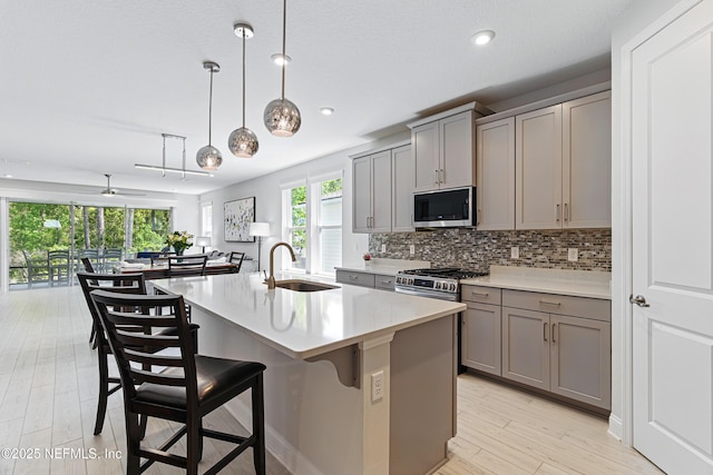 212 Fawnwood St, Saint Johns, FL 32259 - kitchen with a sink, stainless steel appliances, gray cabinetry, and decorative backsplash
