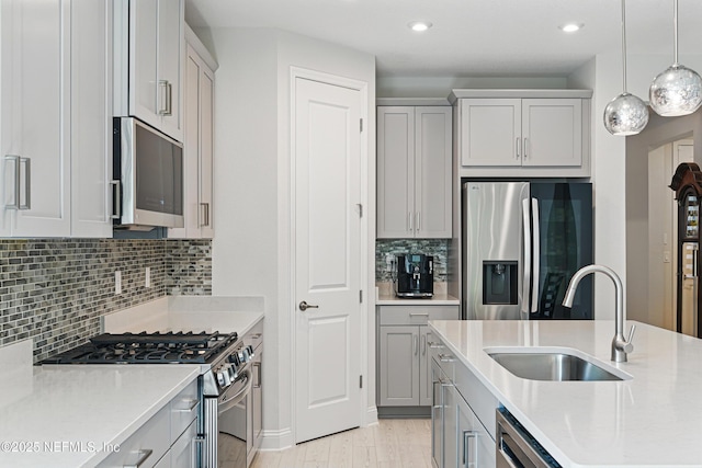 212 Fawnwood St, Saint Johns, FL 32259 - kitchen with light countertops, light wood finished floors, appliances with stainless steel finishes, a sink, and decorative light fixtures