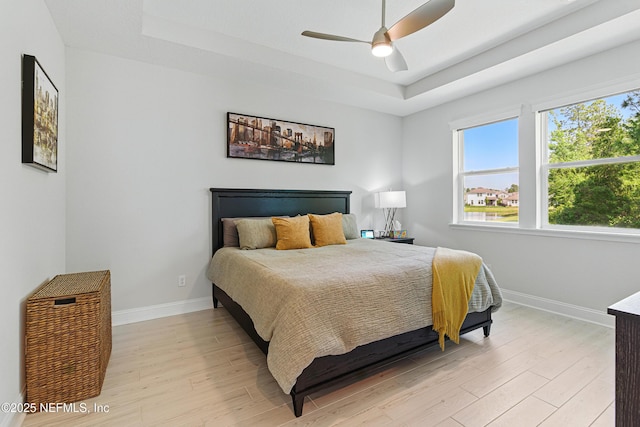 212 Fawnwood St, Saint Johns, FL 32259 - bedroom featuring a ceiling fan, a tray ceiling, baseboards, and light wood-type flooring