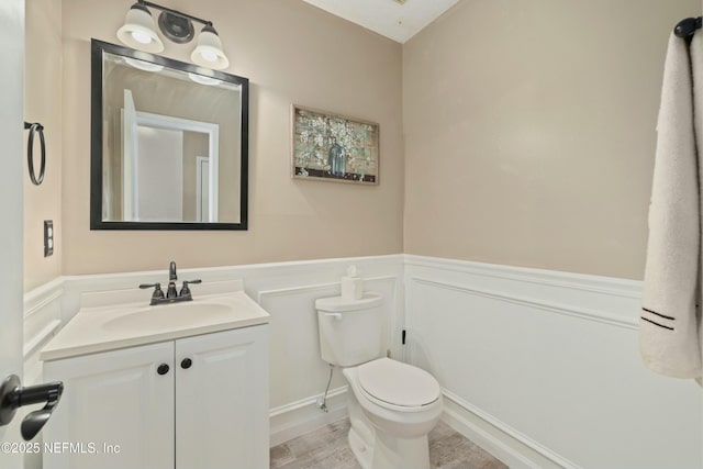4133 Hidden Branch Dr N, Jacksonville, FL 32257 - half bathroom featuring wainscoting, toilet, a decorative wall, and vanity