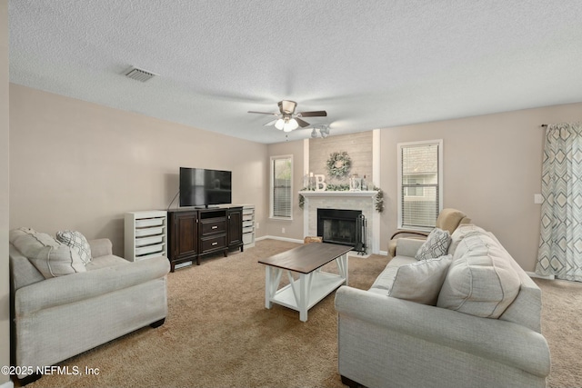 4133 Hidden Branch Dr N, Jacksonville, FL 32257 - living area with a textured ceiling, visible vents, carpet, a fireplace, and ceiling fan