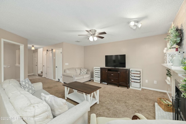 4133 Hidden Branch Dr N, Jacksonville, FL 32257 - living room with a fireplace with flush hearth, a textured ceiling, baseboards, ceiling fan, and light colored carpet