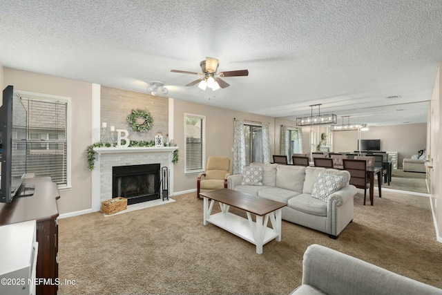 4133 Hidden Branch Dr N, Jacksonville, FL 32257 - living room with a fireplace with flush hearth, a textured ceiling, ceiling fan, and carpet