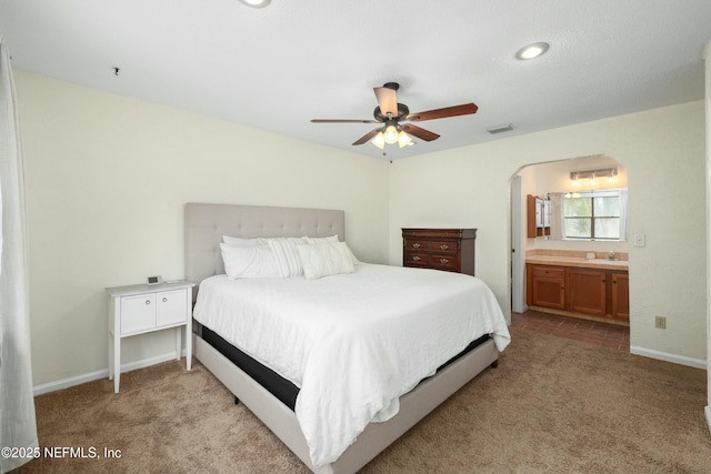 4133 Hidden Branch Dr N, Jacksonville, FL 32257 - bedroom with light carpet, visible vents, arched walkways, and a sink