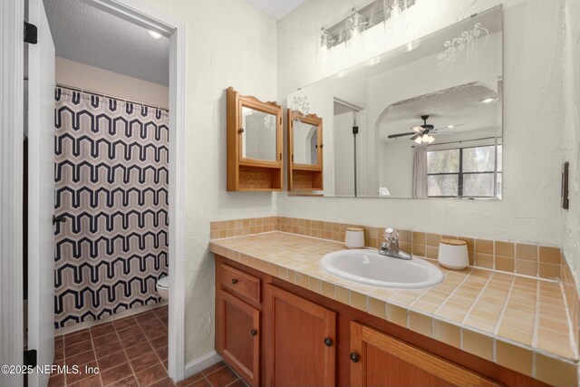 4133 Hidden Branch Dr N, Jacksonville, FL 32257 - bathroom with tile patterned floors, toilet, vanity, a textured ceiling, and ceiling fan