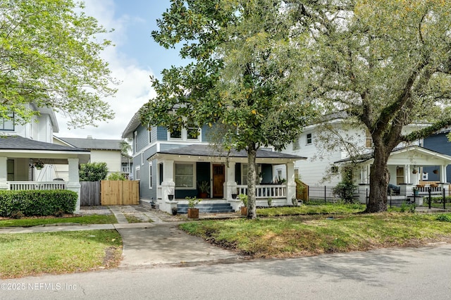 2855 Post St, Jacksonville, FL 32205 - american foursquare style home with fence, a porch, and concrete driveway