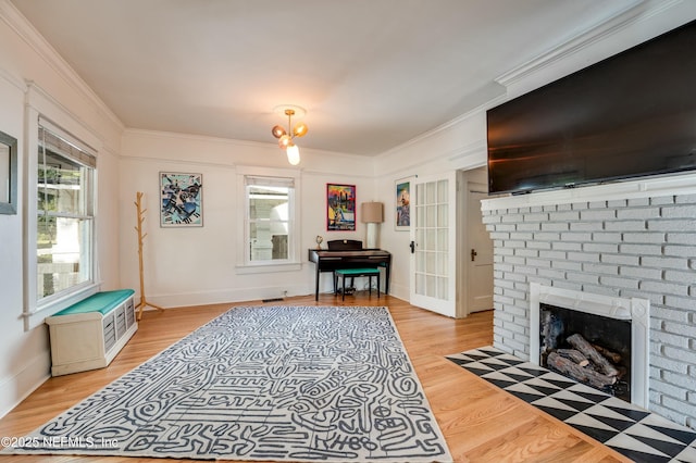 2855 Post St, Jacksonville, FL 32205 - living area featuring baseboards, ornamental molding, light wood-type flooring, and a brick fireplace